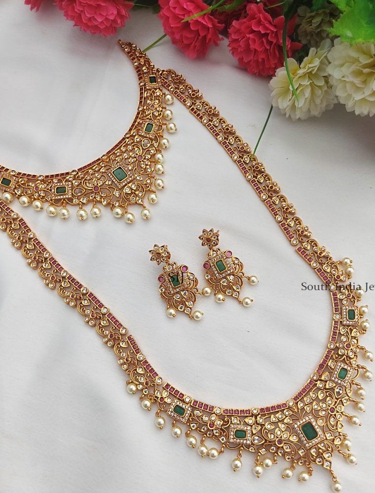 Descriptions: Beautiful mango design haram and matching earrings studded with pink and green stones and pearl. Style it with your favorite lehenga or saree for a complete look. Details & Specifications: Materials Used : Brass with High quality Matte Polish Stone – red, green. Weight : Haram - 68 Gram, Earring - 15 grams. Length  : Haram -55 cms ,Earrings-2 cms Fastening: Thread, earrings – pushback