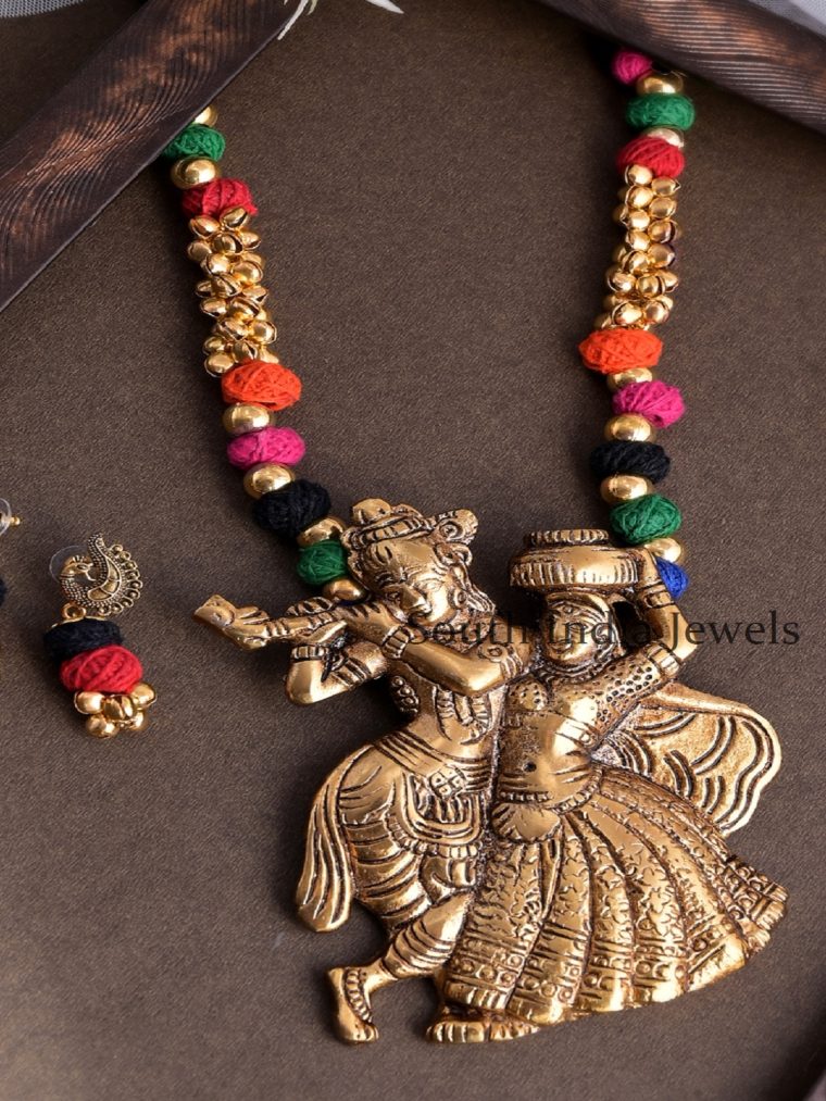 Exquisite Krishna Designed Pendant In Antique Gold Plated Colorful Necklace Set With Ghunghroos