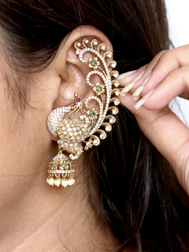 Matte finish flower design earcuff jhumkas embody delicate beauty and modern charm. These earrings feature intricate floral patterns with a matte finish, offering a subtle yet striking allure. The earcuff design adds a contemporary twist, making them a versatile accessory for both casual and formal occasions, enhancing any ensemble with elegance and sophistication.