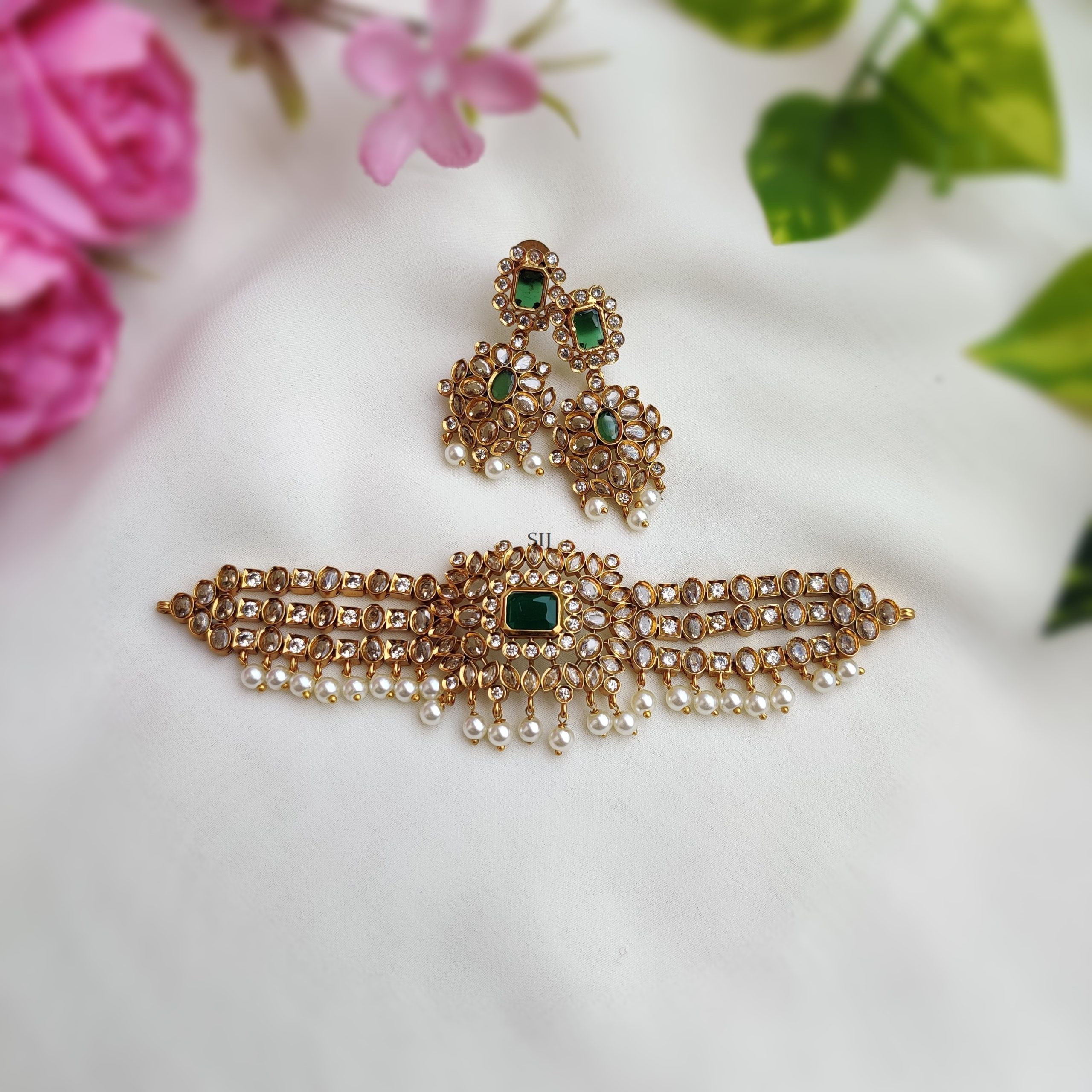 A stunning white pearl green Kundan choker set, epitomizing opulence and elegance. The radiant green Kundan stones harmonize with lustrous white pearls, exuding regal charm. Meticulously crafted with intricate detailing, it adds a touch of sophistication to any attire, perfect for those seeking to make a statement with timeless grace. A stunning white pearl green Kundan choker set, epitomizing opulence and elegance. The radiant green Kundan stones harmonize with lustrous white pearls, exuding regal charm. Meticulously crafted with intricate detailing, it adds a touch of sophistication to any attire, perfect for those seeking to make a statement with timeless grace. A stunning white pearl green Kundan choker set, epitomizing opulence and elegance. The radiant green Kundan stones harmonize with lustrous white pearls, exuding regal charm. Meticulously crafted with intricate detailing, it adds a touch of sophistication to any attire, perfect for those seeking to make a statement with timeless grace. A stunning white pearl green Kundan choker set, epitomizing opulence and elegance. The radiant green Kundan stones harmonize with lustrous white pearls, exuding regal charm. Meticulously crafted with intricate detailing, it adds a touch of sophistication to any attire, perfect for those seeking to make a statement with timeless grace. White Pearl Green Kundan Choker set