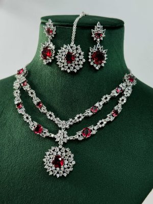 Silver Plated Flower Design Red Stone AD Necklace With Earrings And Maang Tikka