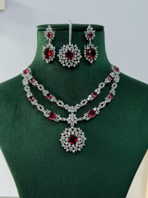 Silver Plated Flower Design Red Stone AD Necklace With Earrings And Maang Tikka